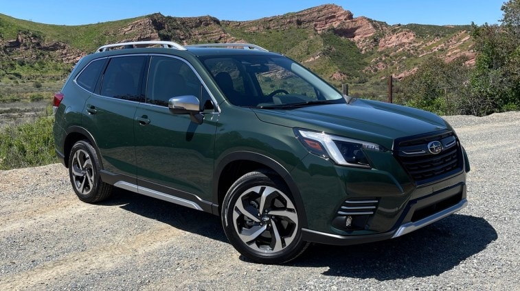 2023 Subaru Forester in green with red hills in the background.