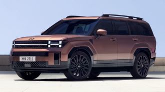 Front view of the redesigned 2024 Hyundai Santa Fe in bronze