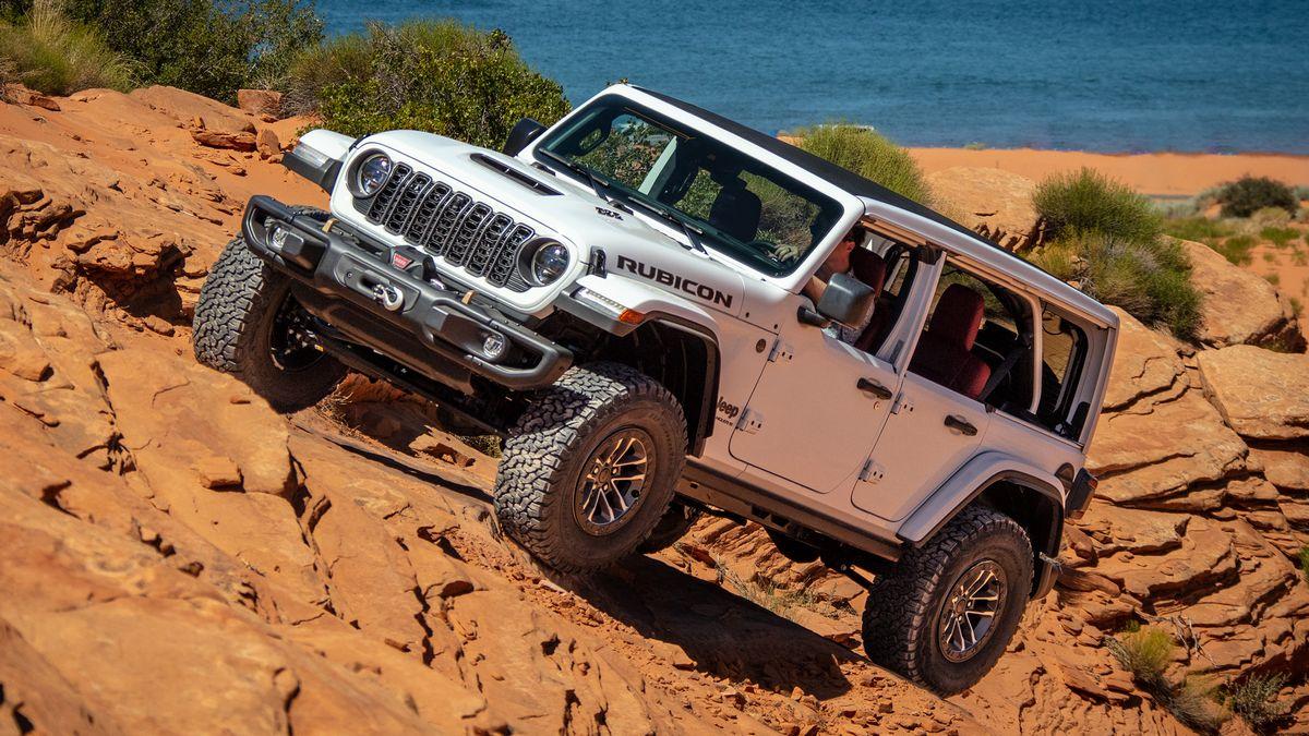 2024 Jeep Wrangler Rubicon 392 in white crawling up a rock face.