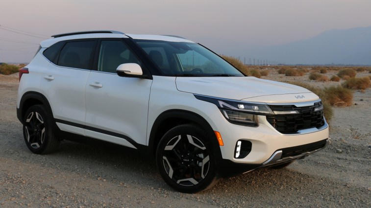 2024 Kia Seltos SX in white near Palm Springs at sunset.