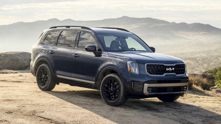 2024 Kia Telluride in blue parked on a hill top.