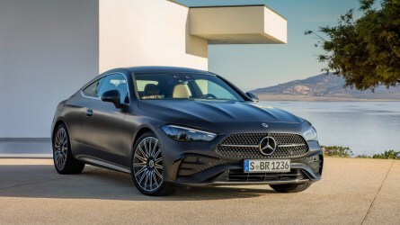 2024 Mercedes-Benz CLE Coupe in grey near a white building next to a lake.
