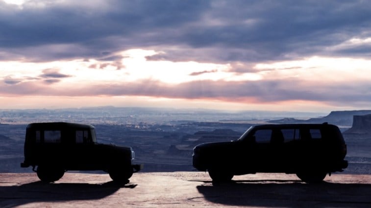A teaser photo showing the silhouette of the 2024 Toyota Land Cruiser facing a classic Toyota BJ from the early 1950s
