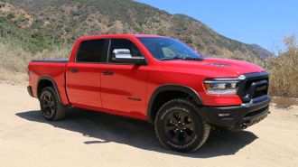 2023 Ram 1500 Rebel G/T in red with hills in the background.