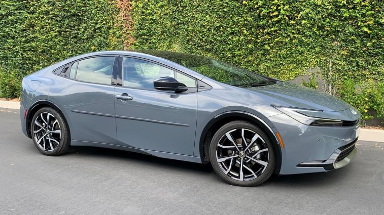 2023 Toyota Prius Prime in grey near an ivy wall.