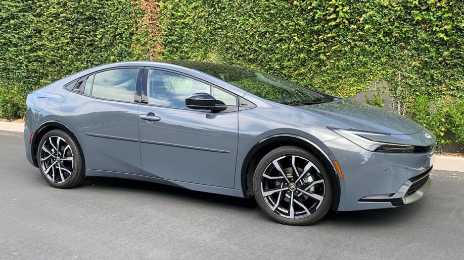 2023 Toyota Prius Prime in grey near an ivy wall.