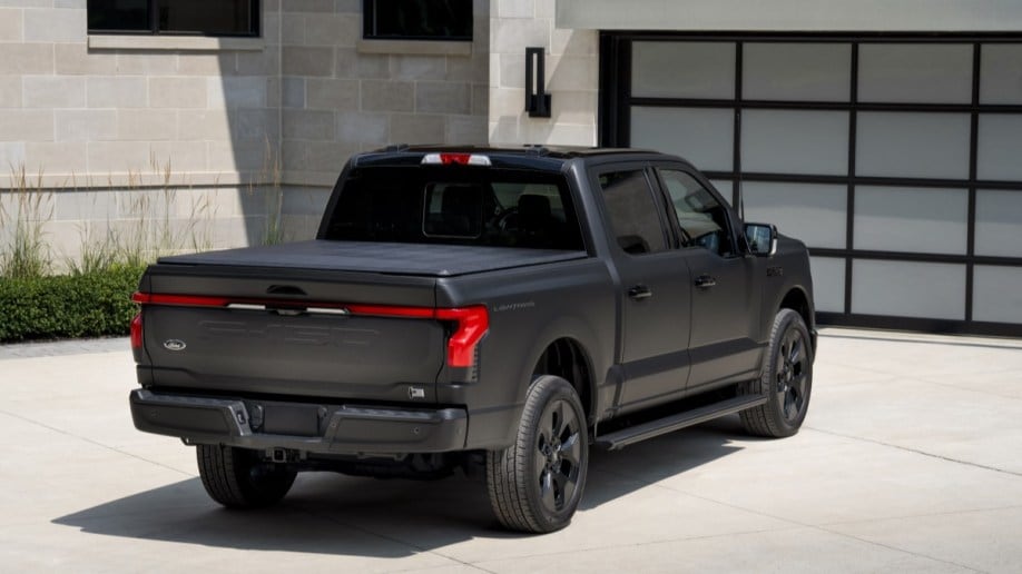 The 2024 Ford F-150 Lightning Platinum Black Edition seen from a rear-quarter angle