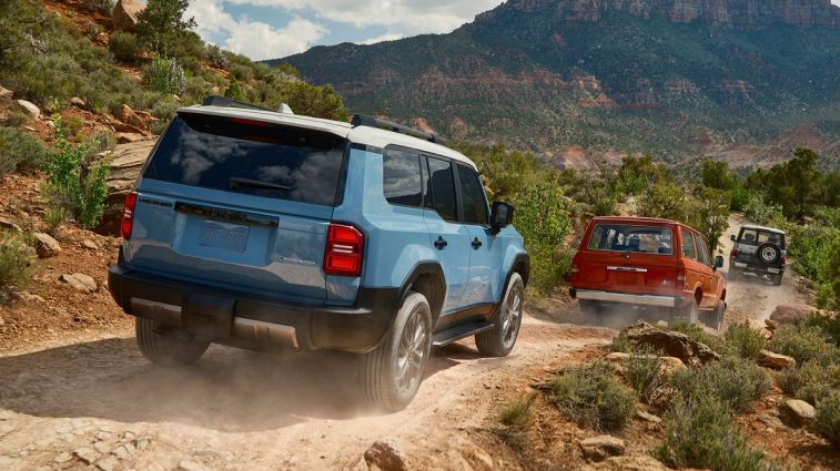 2024 Toyota Land Cruiser in blue driving down a dirt road.
