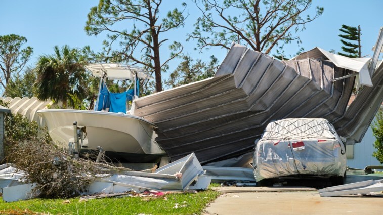 A car and boat outside after a hurricane