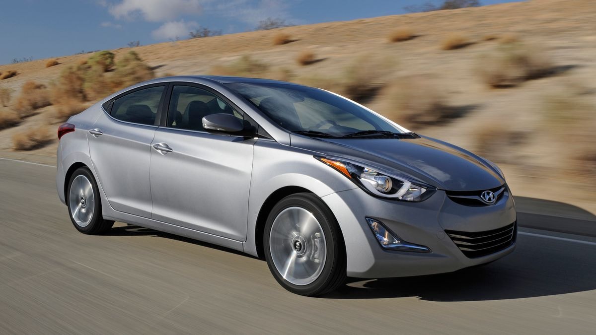 2015 Hyundai Elantra in silver driving on a roadway.