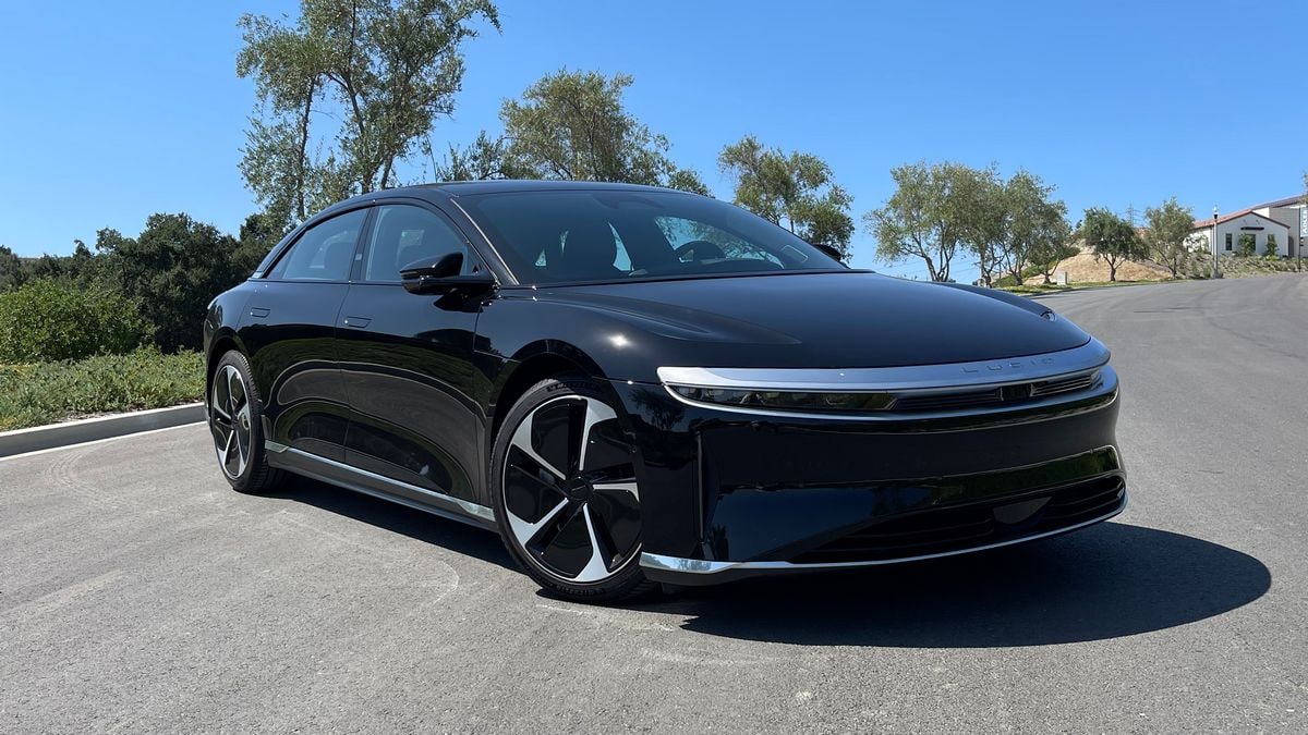 2023 Lucid Air Pure in black with trees in the background.