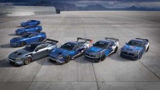 The full lineup of 2024 Ford Mustangs parked together on a track