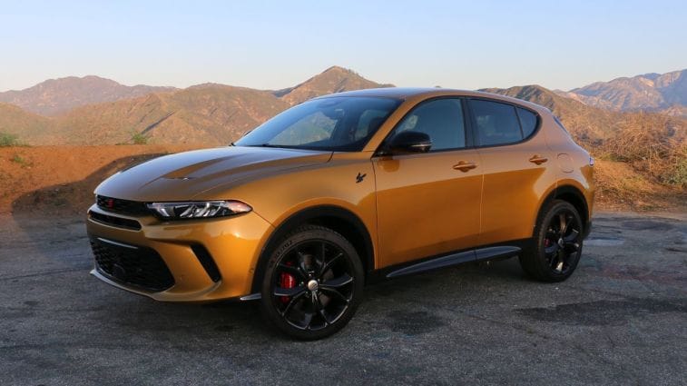 2024 Dodge Hornet RT PHEV in gold with hills in the background.