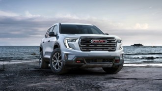 The 2024 GMC Acadia seen from a front quarter angle.