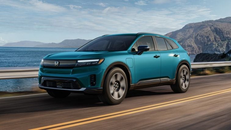 2024 Honda Prologue Elite in blue driving on a highway.