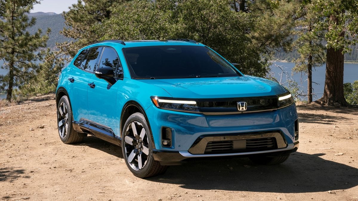 2024 Honda Prologue Elite in blue with trees in the background.