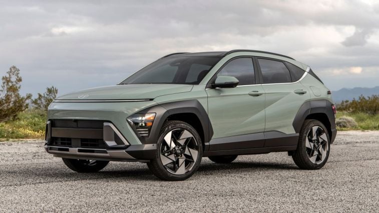 2024 Hyundai Kona Limited in green with clouds in the background.