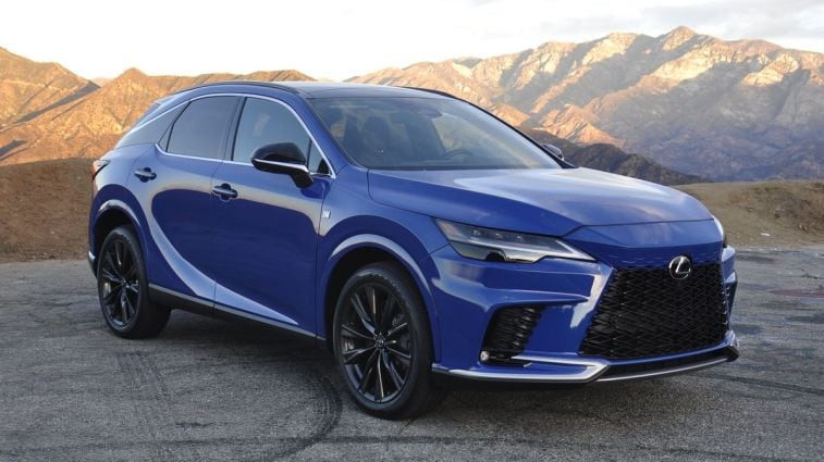 2024 Lexus RX350 F Sport in blue with mountains in the background.