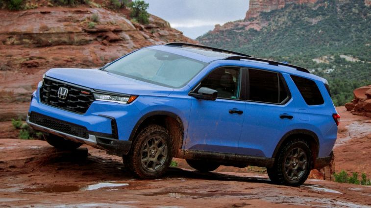 2023 Honda Pilot in blue off-roading.