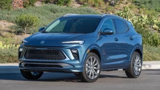 2024 Buick Encore GX Avenir with shrubs in the background.
