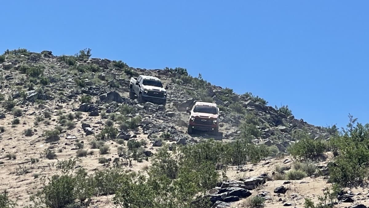 A pair of 2024 Chevrolet Silverado ZR Bisons navigate downhill