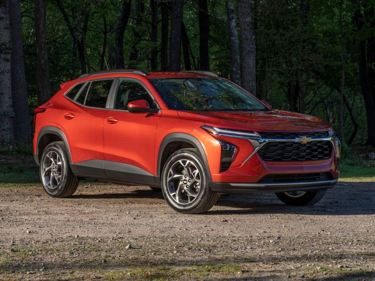 2024 Chevrolet Trax LT in red near a forest.