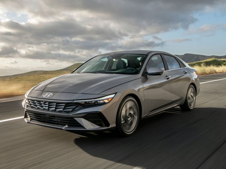 2024 Hyundai Elantra sedan in grey with clouds in the background.