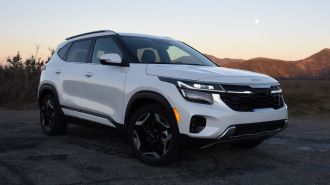 2024 Kia Seltos in white with hills in the background.