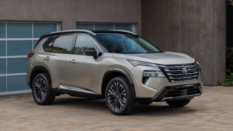 2024 Nissan Rogue parked in front of a garage.