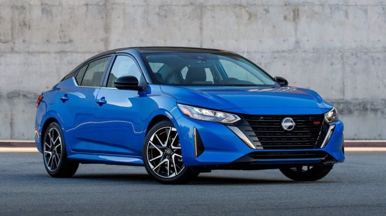 2024 Nissan Sentra in blue near a concrete wall.