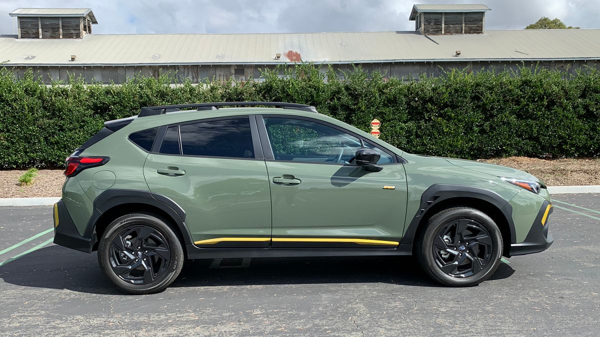 2024 Subaru Crosstrek Sport in green near bushes.