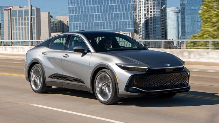 2024 Toyota Crown Limited in Heavy Metal driving down a highway.