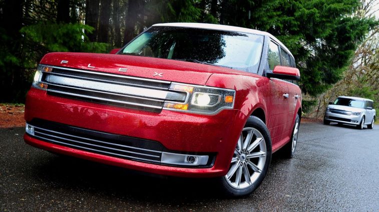 2017 Ford Flex in red parked near tall trees.