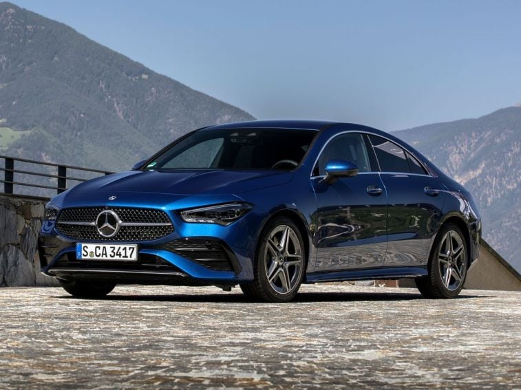 2023 Mercedes-Benz CLA in blue with mountains in the background.
