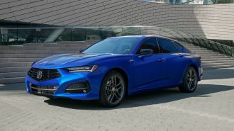 2024 Acura TLX A Spec in blue parked in front of a building.