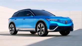 2024 Acura ZDX Type S in blue with a concrete wall in the background.