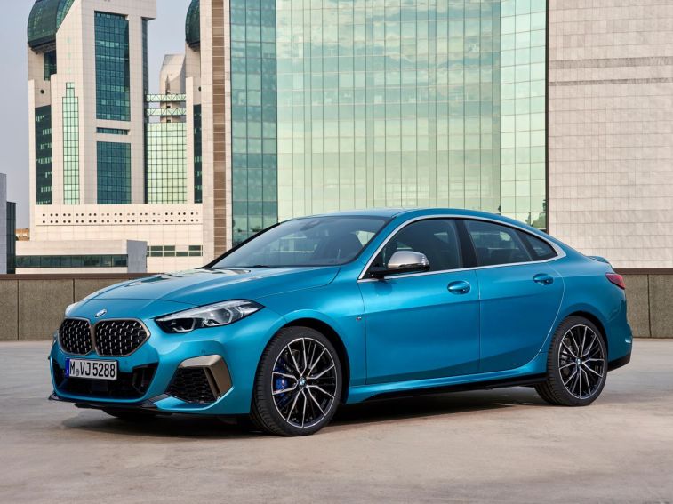 2024 BMW 2 Series Gran Coupe in blue near an office building.