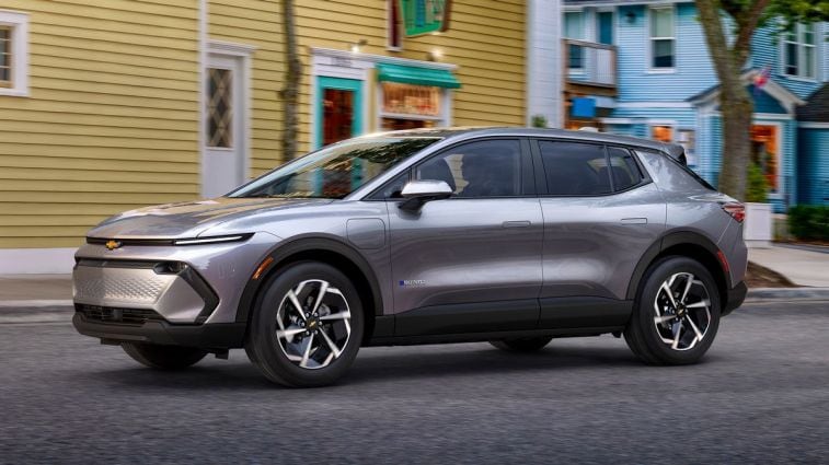 2024 Chevrolet Equinox EV 1LT in Galaxy Gray Metallic driving down a road.