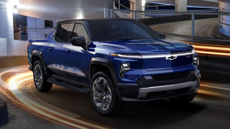 2024 Silverado EV RST in blue driving down a parking ramp.
