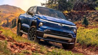 2024 Silverado EV RST in blue off roading.