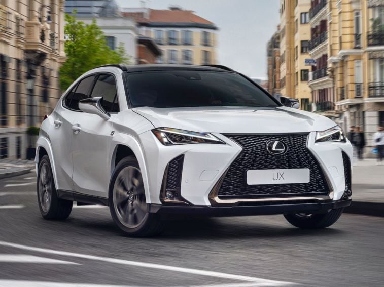 2024 Lexus UXh F-Sport driving around a city street.