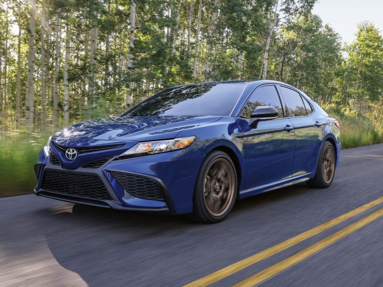 2024 Toyota Camry SE Nightshade driving on a highway.