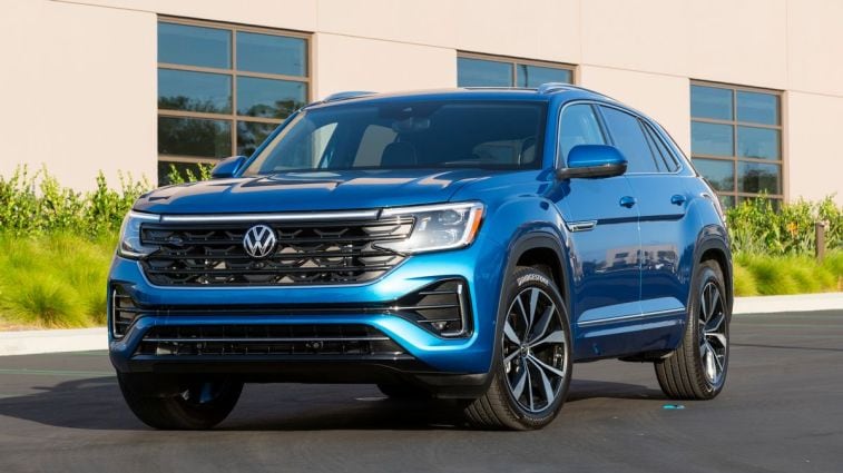 2024 Volkswagen Atlas Cross Sport in blue near a building.