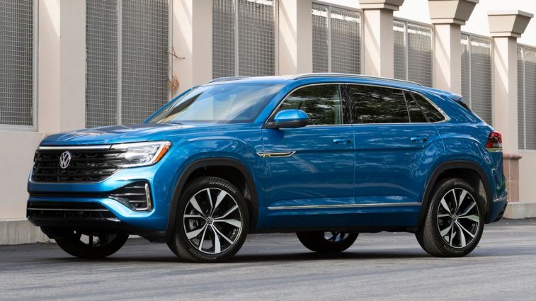 2024 Volkswagen Atlas Cross Sport in blue near a building.