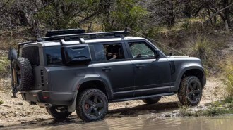 A Land Rover Defender 130 competing in an off-road event