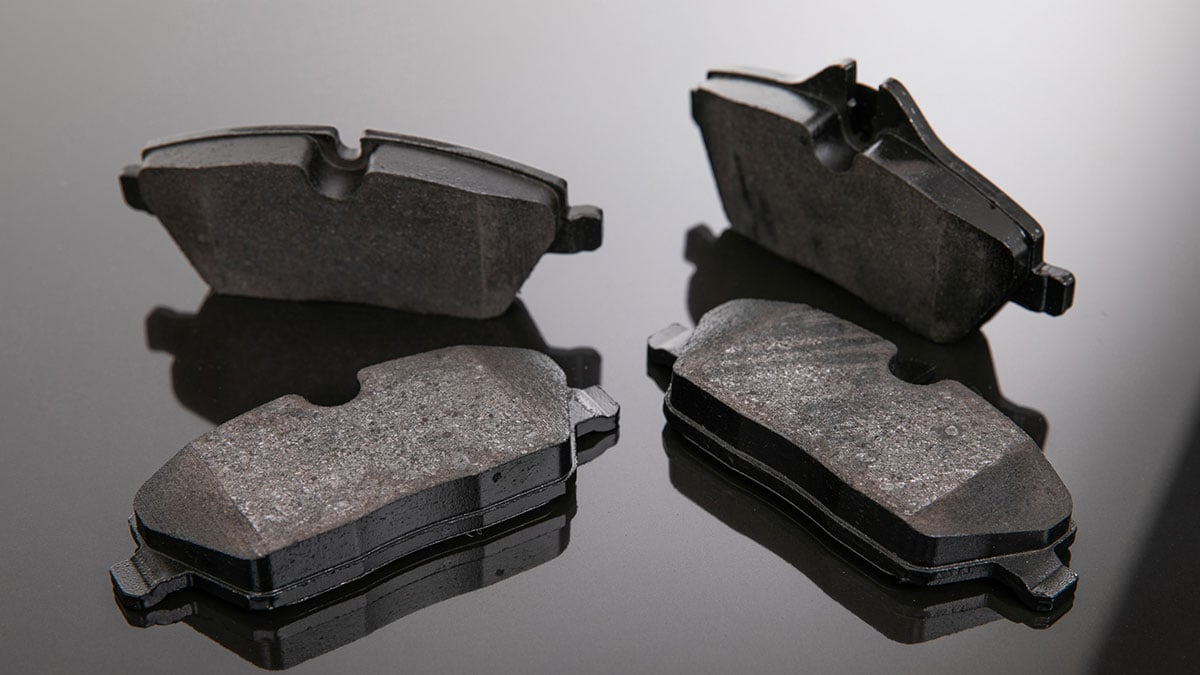 Set of brake pads on a mirror background