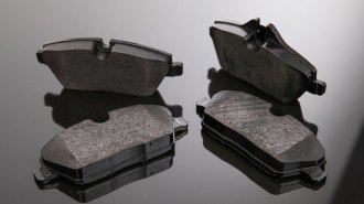 Set of brake pads on a mirror background