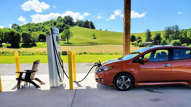 The Nissan Leaf charging at a covered charging facility