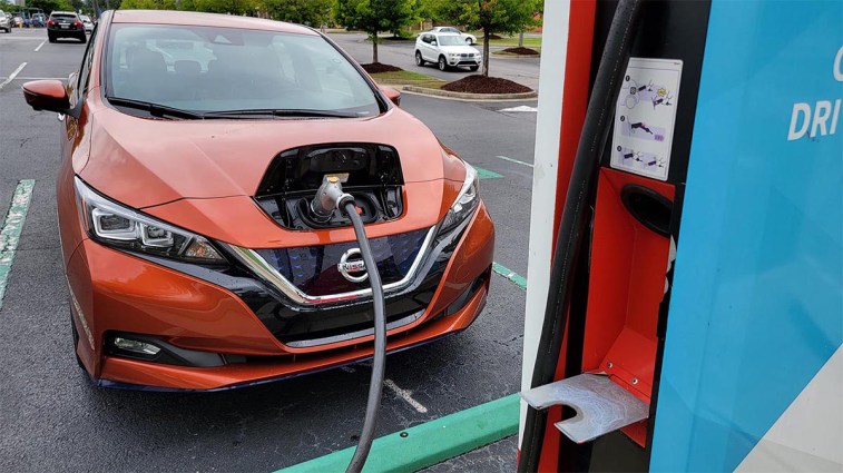 The Nissan Leaf charges in a grocery lot.