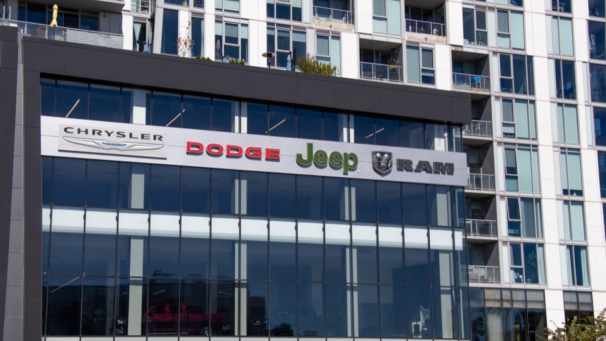 A dealership sign showing Stellantis brands